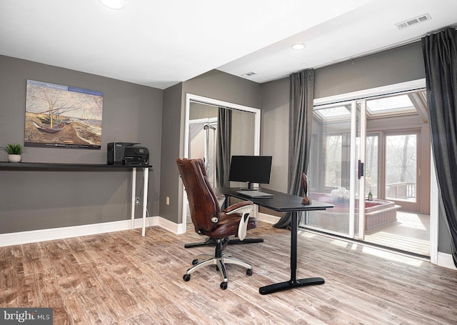 office with visible vents, recessed lighting, baseboards, and wood finished floors