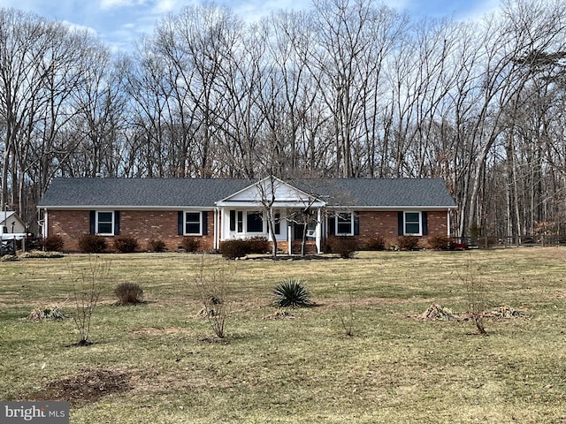 ranch-style home with a front yard and brick siding