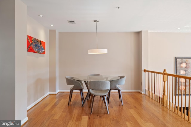 dining area with light wood-style floors, baseboards, visible vents, and recessed lighting