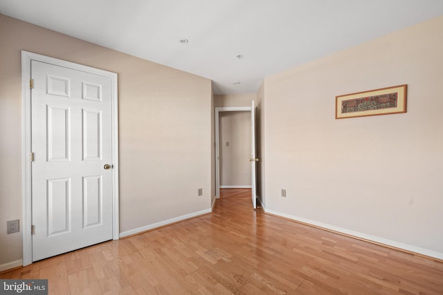 unfurnished bedroom with light wood-style floors and baseboards