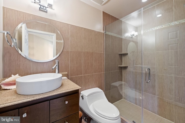 full bath with tile walls, visible vents, toilet, a stall shower, and vanity