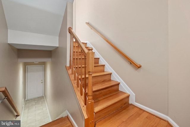 staircase featuring baseboards