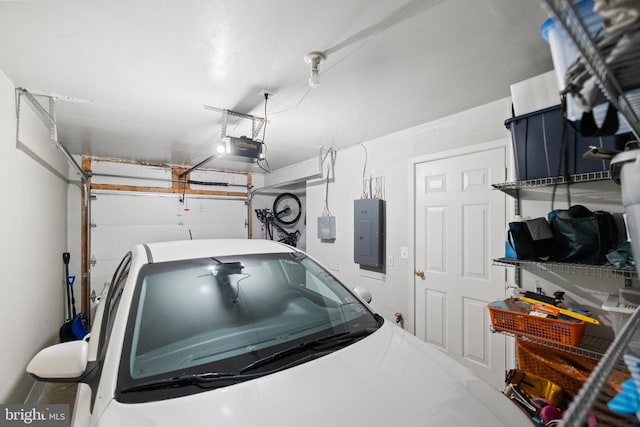 garage featuring electric panel and a garage door opener