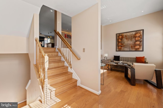 stairway featuring baseboards and wood finished floors