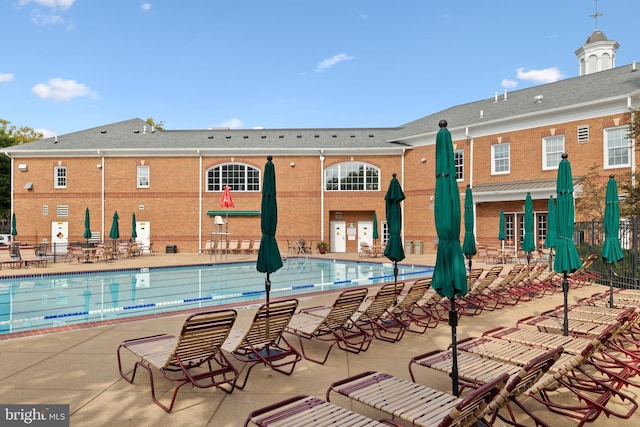 pool with fence and a patio