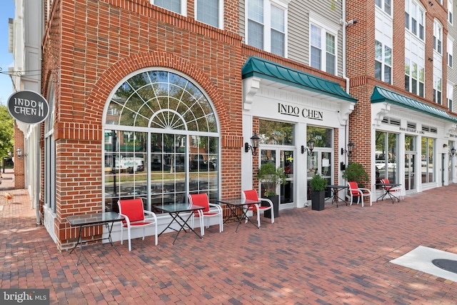 view of exterior entry with french doors and brick siding