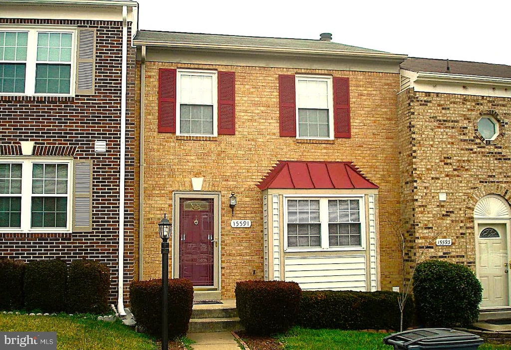 view of property featuring brick siding