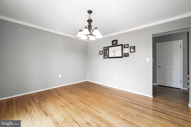 unfurnished room featuring baseboards, light wood finished floors, and crown molding