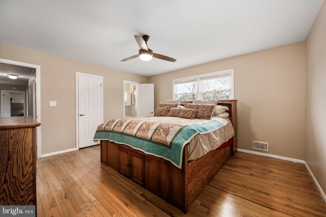 bedroom featuring a ceiling fan, baseboards, visible vents, and light wood finished floors