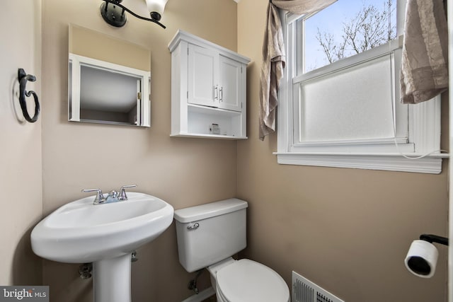 bathroom featuring visible vents and toilet