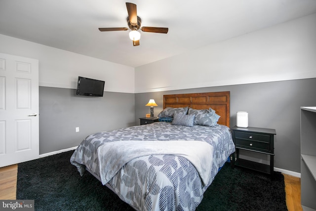 bedroom featuring ceiling fan, wood finished floors, and baseboards