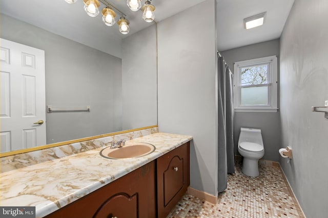 full bathroom with toilet, tile patterned floors, vanity, and baseboards