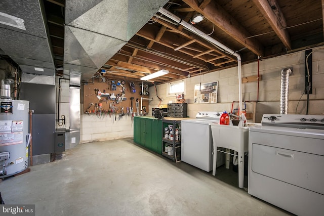 basement with washing machine and dryer and water heater