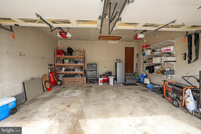 garage with freestanding refrigerator and a garage door opener