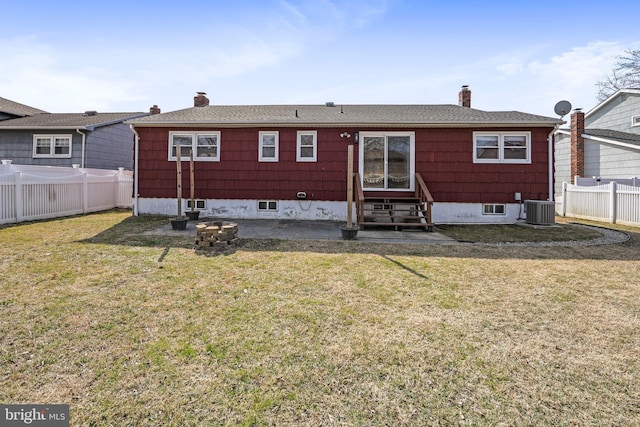 rear view of house featuring a chimney, central air condition unit, a lawn, entry steps, and fence