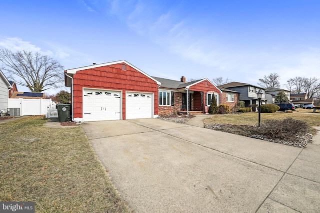 ranch-style house with central air condition unit, concrete driveway, a gate, fence, and a garage