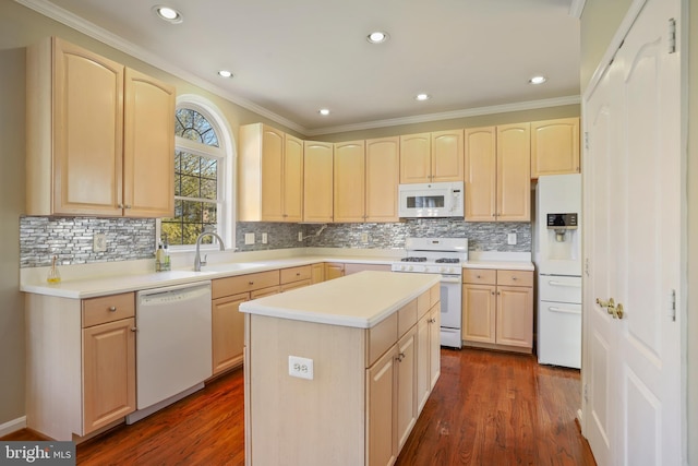 kitchen with white appliances, light brown cabinets, dark wood-type flooring, and a sink