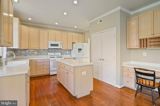 kitchen featuring light brown cabinets, white appliances, a sink, visible vents, and dark wood-style floors