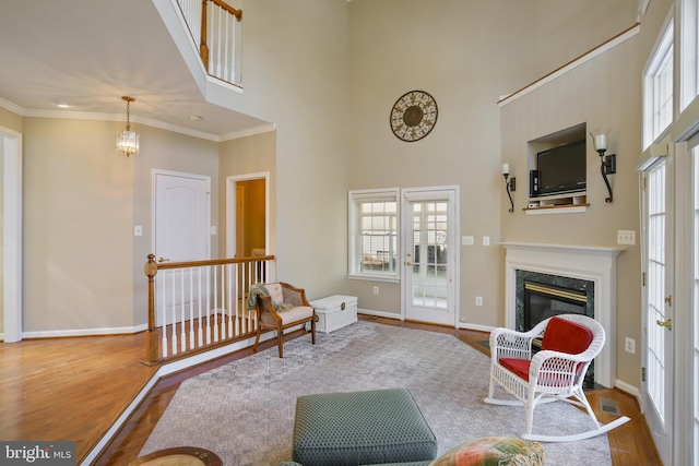 interior space featuring plenty of natural light, crown molding, and wood finished floors