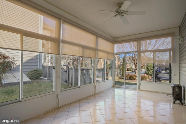 unfurnished sunroom featuring a ceiling fan