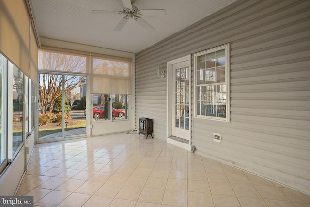 unfurnished sunroom with a ceiling fan