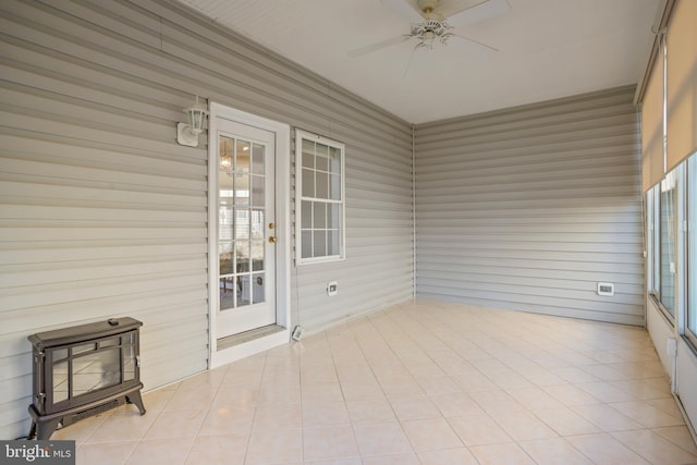 unfurnished sunroom with french doors and a ceiling fan