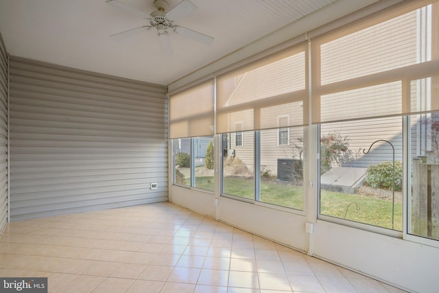 unfurnished sunroom featuring ceiling fan