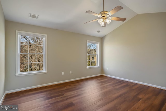 unfurnished room with dark wood finished floors, visible vents, and baseboards