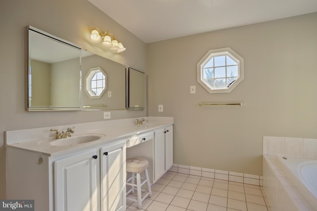 full bath with tile patterned flooring, double vanity, a sink, and tiled tub