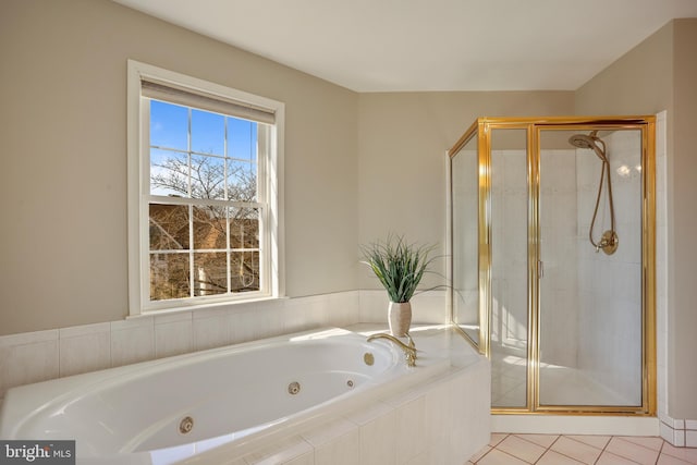 full bath featuring a jetted tub, a shower stall, and tile patterned floors