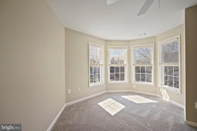 spare room with visible vents, carpet, a ceiling fan, and baseboards