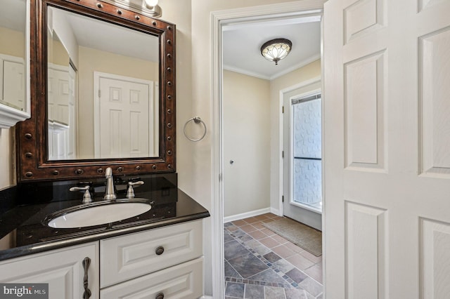 bathroom featuring vanity, baseboards, and ornamental molding