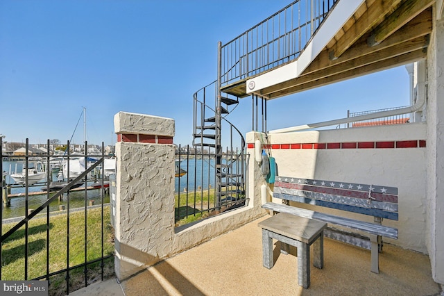 view of patio / terrace with a water view and a boat dock