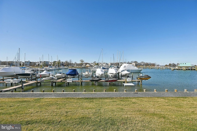 dock area featuring a lawn, a water view, and boat lift