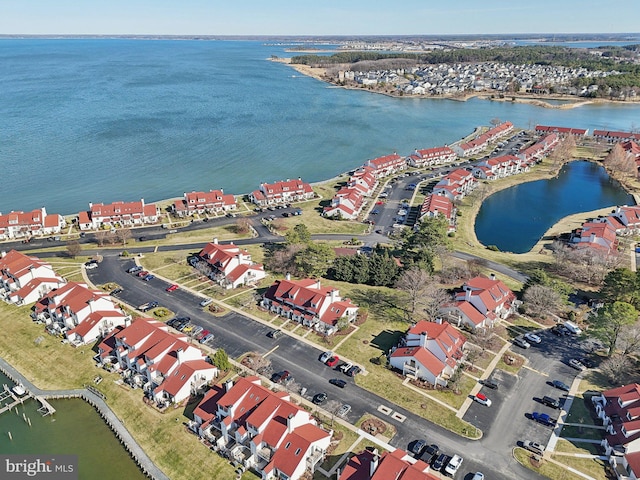 drone / aerial view featuring a residential view and a water view