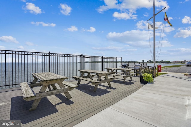 wooden terrace featuring a water view