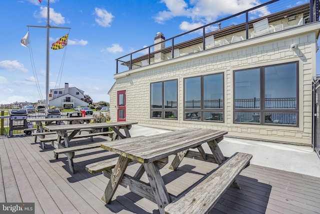 wooden terrace with outdoor dining area