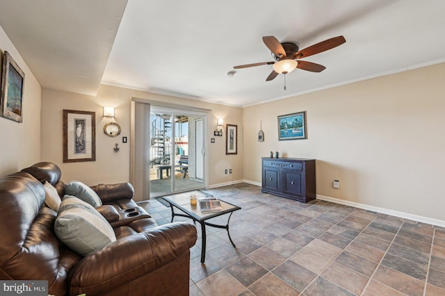 living area with ceiling fan, crown molding, and baseboards