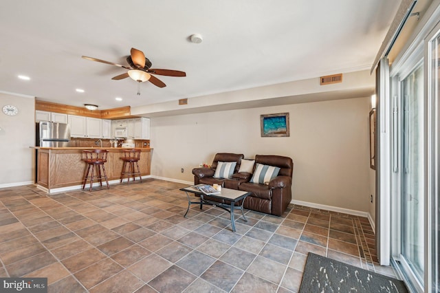 living room featuring visible vents, recessed lighting, baseboards, and ceiling fan