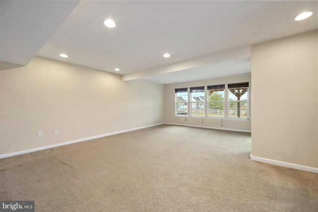 empty room featuring carpet flooring, recessed lighting, and baseboards