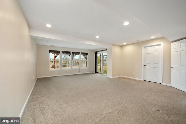 carpeted spare room featuring recessed lighting and baseboards