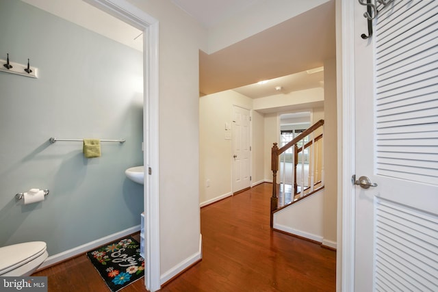 bathroom with baseboards, toilet, and wood finished floors