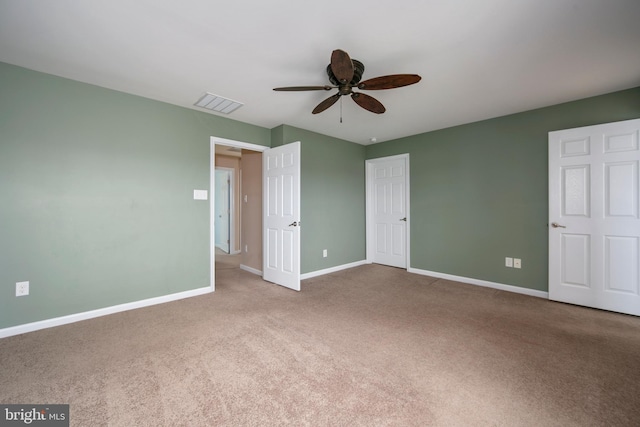 unfurnished bedroom featuring visible vents, ceiling fan, baseboards, and carpet floors