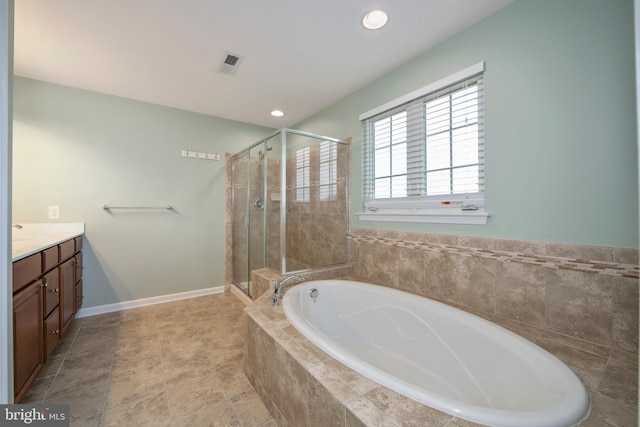 full bath featuring visible vents, baseboards, a garden tub, a stall shower, and vanity