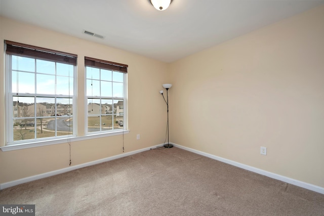 unfurnished room featuring baseboards and carpet