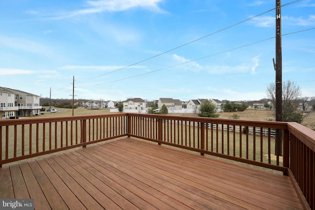 wooden terrace with a residential view and a yard