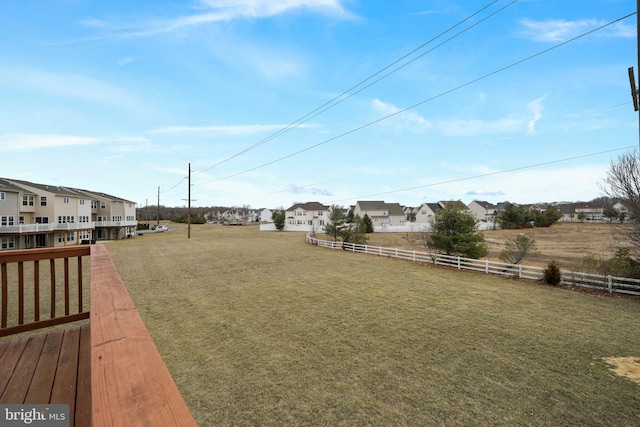 view of yard featuring a residential view and fence