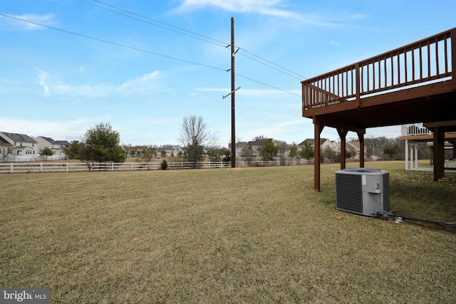 view of yard featuring central AC unit and fence