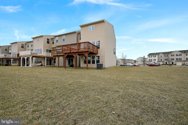 back of property featuring a residential view, a lawn, and cooling unit