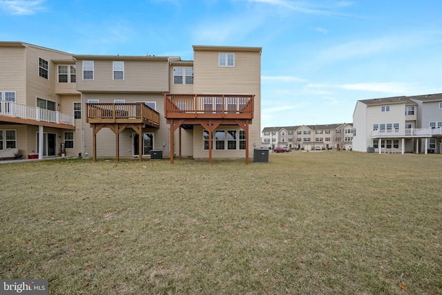 back of house featuring a yard and central AC unit